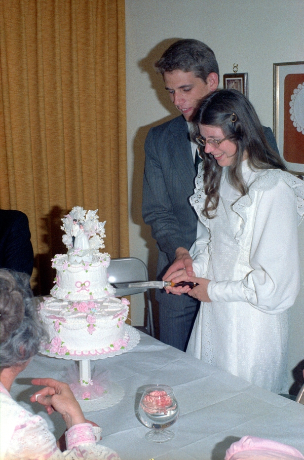 Don and Lois Colton cutting the cake at their wedding reception, 1975