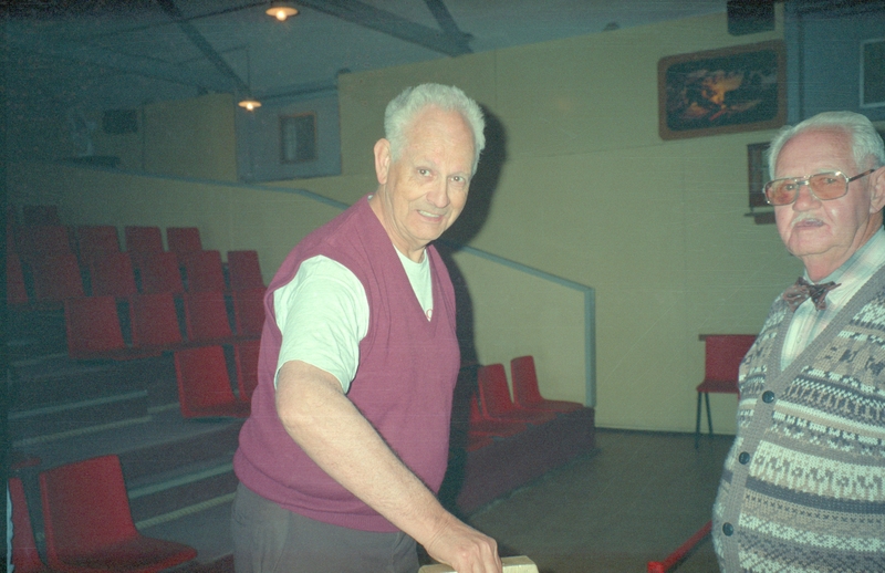 Larry Colton tries to pick up the ingot.