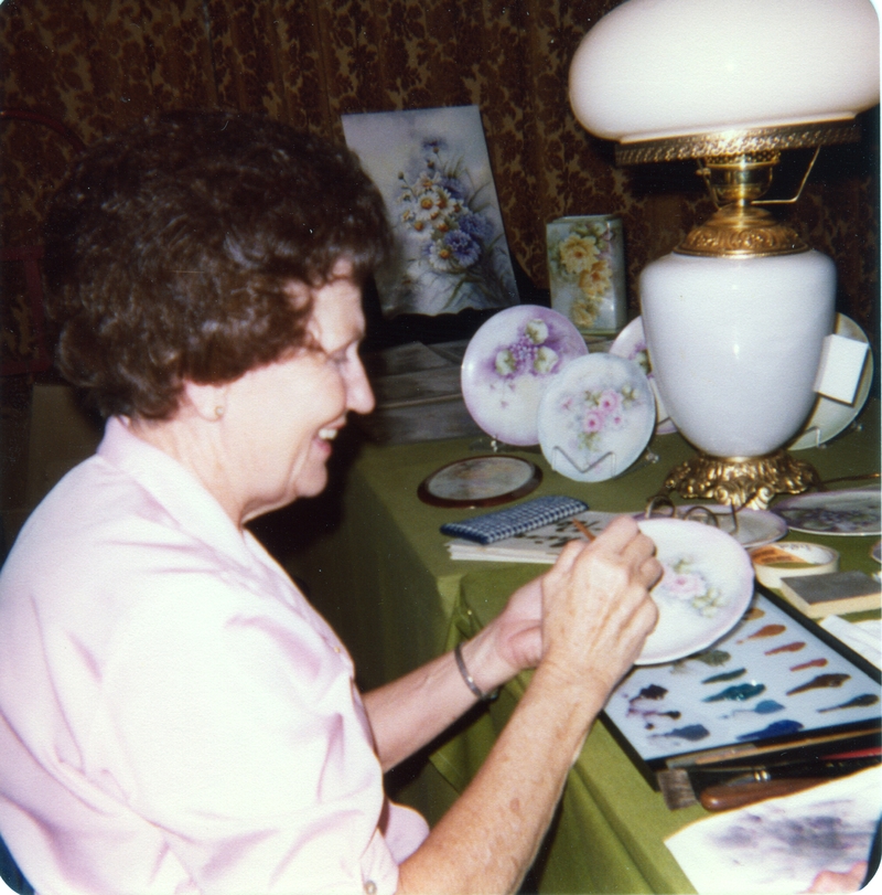 Edna Larson painting a plate