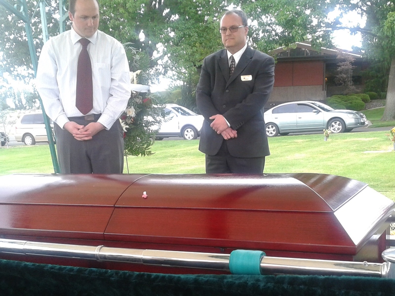 The casket is descending slowly.